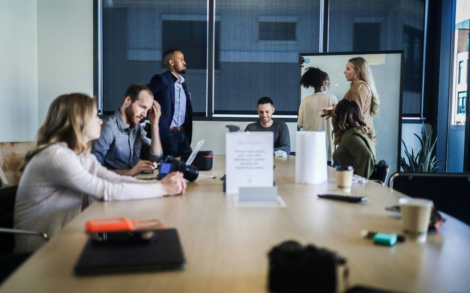 A working group in conversation around a meeting table